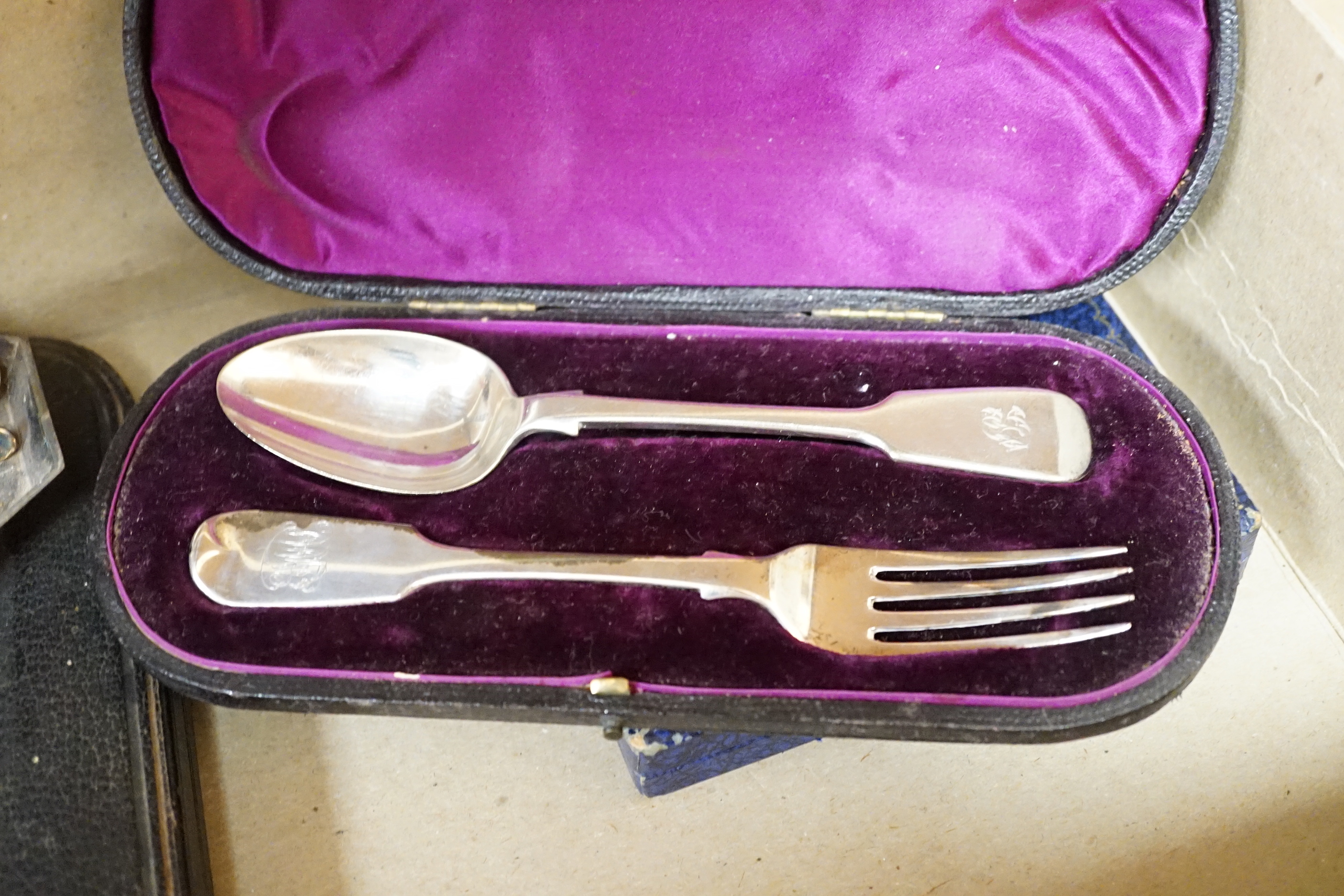 A group of assorted cased flatware comprising a set of six silver coffee spoons, Birmingham 1949, 100 grams, a silver fork and plated spoon christening set, fork 49 grams, a set of five Edwardian silver teaspoons and ton